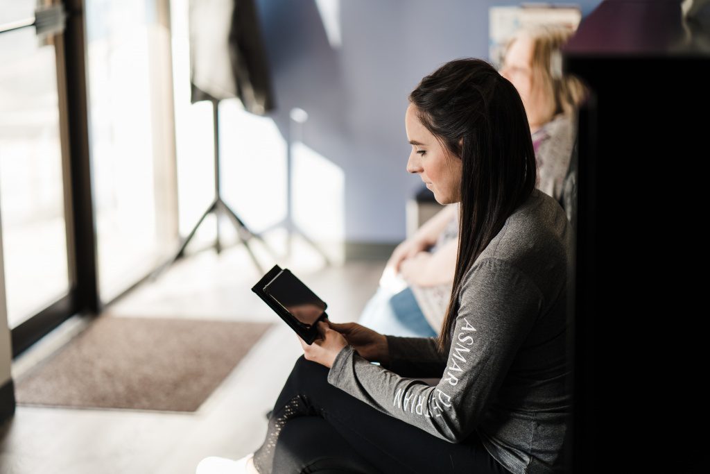 Royal Oak Dental Patient Using Tablet in Waiting Room
