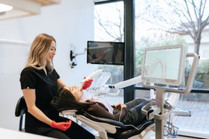 Cosmetic Dentistry procedure under a 3D scanner for dental imaging