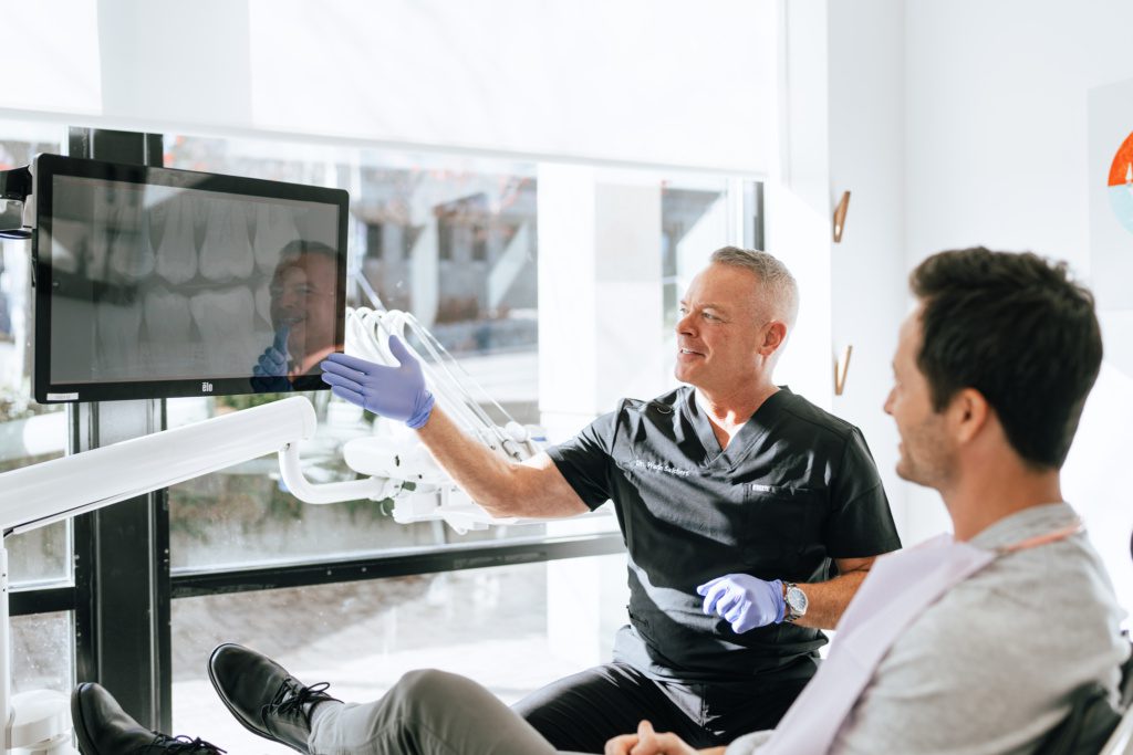 Dentist Salchert consults with a patient using dental imaging technology
