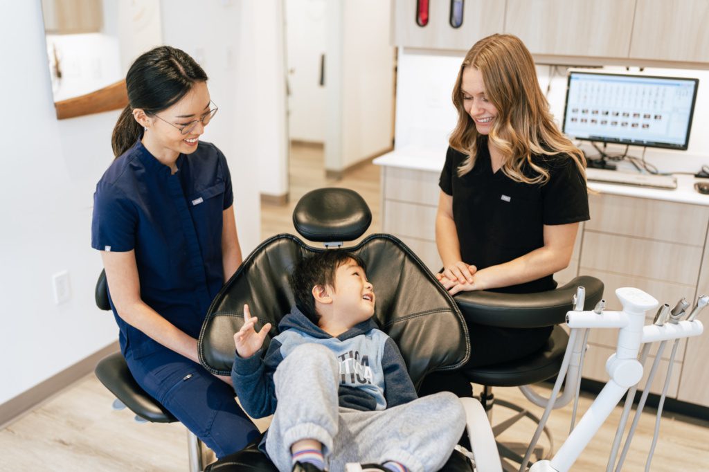 Anxiety free and friendly dentist interact with child patient